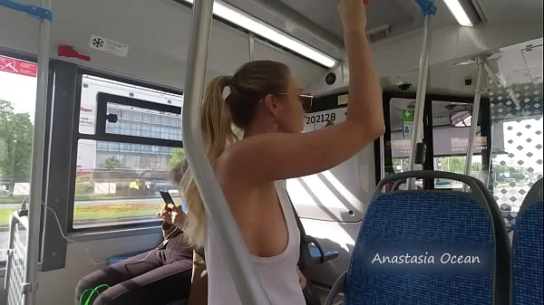 A girl rides a public bus with bare breasts